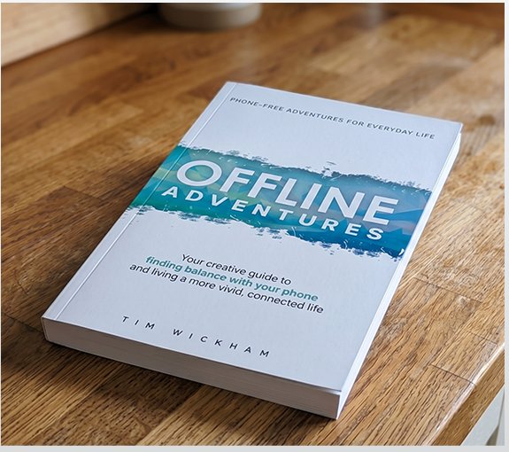 Offline Adventures paperback on a wooden table